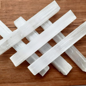 A few selenite sticks stacked together.